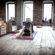 woman in dog pose in a yoga studio 